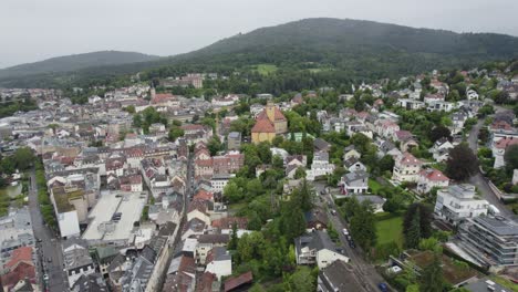 un avión se acerca al gimnasio markgraf-ludwig, un llamativo edificio escolar amarillo en baden-baden, alemania.