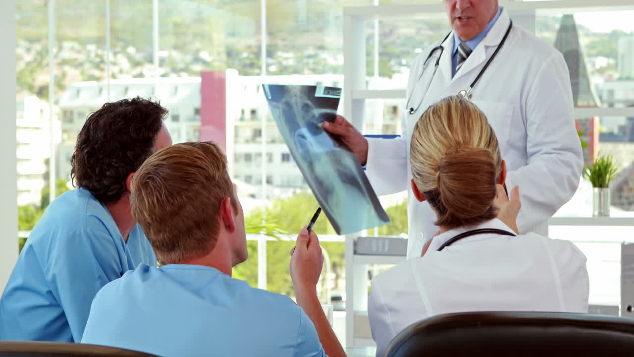 Doctors showong Xray to his colleagues
