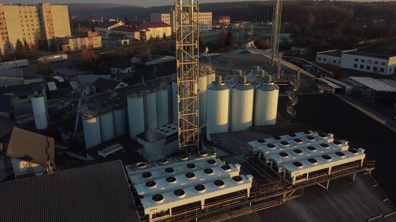 Aerial view of a drone flying over the beer production plant, several rows of tanks.