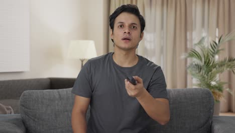 indian man sees a shocking news on tv
