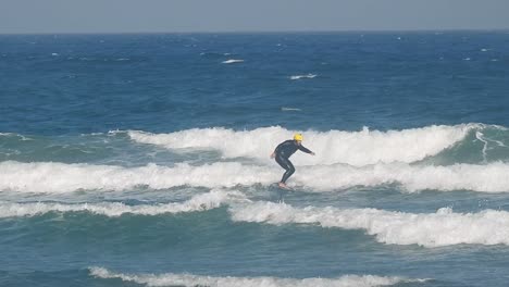 fast foiler on ocean waves, elevated by a hydrofoil with strong wind, flying the surface at high speed, creating spray and dynamic energy. very fast
