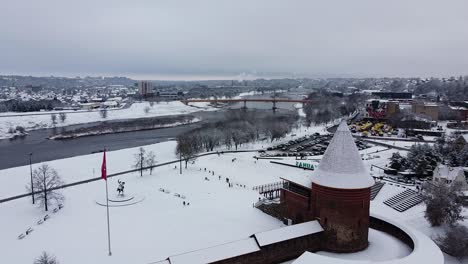 Aerial-side-shot-of-Kaunes-Castle-in-cold-and-snowy-winter-season