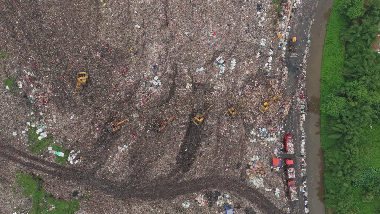 Aerial view of a large landfill with excavators working