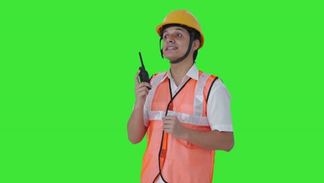 Happy-Indian-architect-giving-directions-on-walkie-talkie-Green-screen