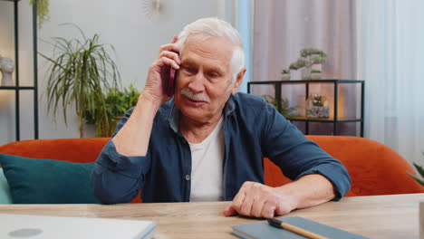 happy senior old man involved in pleasant conversation phone call good news enjoying talking gossip