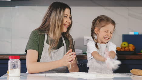 mother-and-daughter-clap-their-hands-with-flour