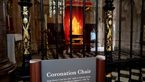 informative panel about king edward i chair in westminster abbey and coronation chair in background