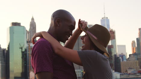 romantic young couple with manhattan skyline in background