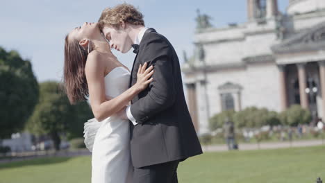 couple kissing in front of a church