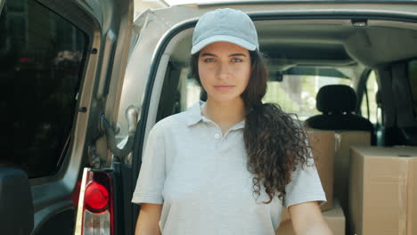 female delivery person in front of van