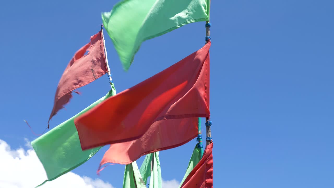 Red and green flags waving in the wind