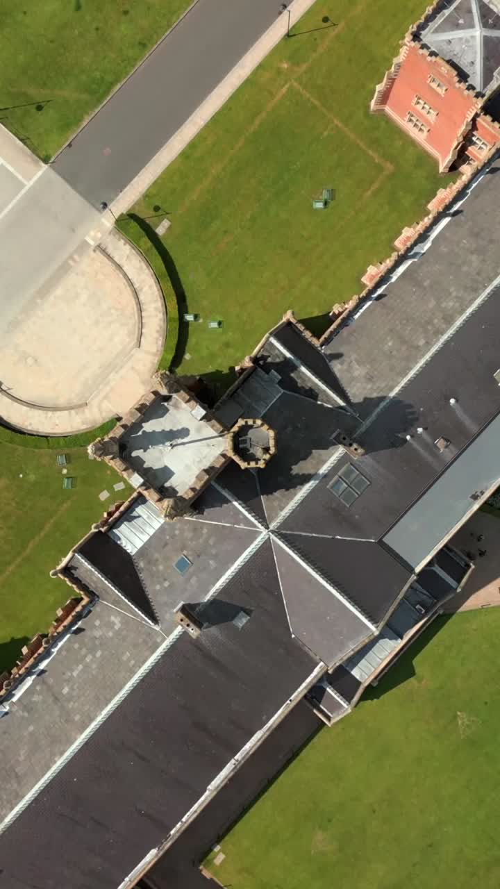 Ascending overhead social ratio aerial video of Queen's University, Belfast on a bright and sunny day. Filmed in 1080x1920, 60fps and with Rec709 color