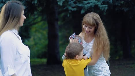 young mother and her son plays with the baby