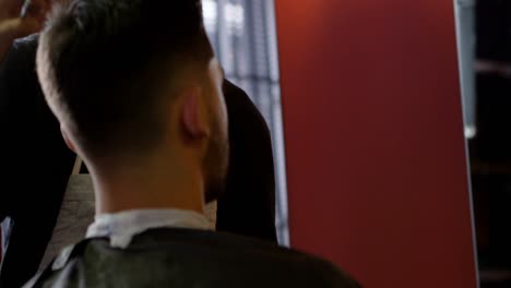 barber trimming clients hair at barber shop 4k