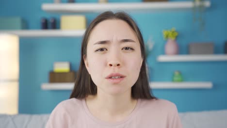 Close-up-portrait-of-angry-Asian-young-woman-talking.