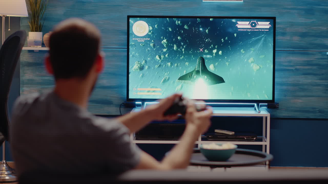 Man playing video games on console using joystick