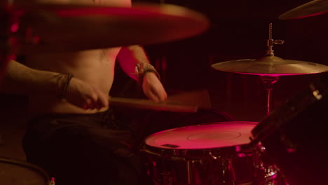 Young-male-drummer-playing-drums-at-music-studio