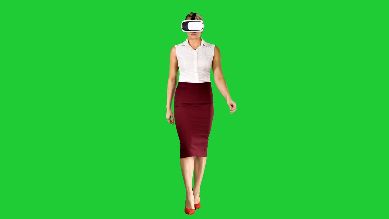 Walking young woman using vr glasses on a Green Screen, Chroma Key
