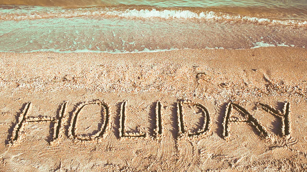 Inscription on sand, the beach. Shooting on the beach