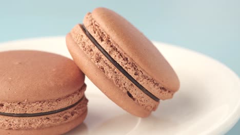 chocolate macarons on a white plate