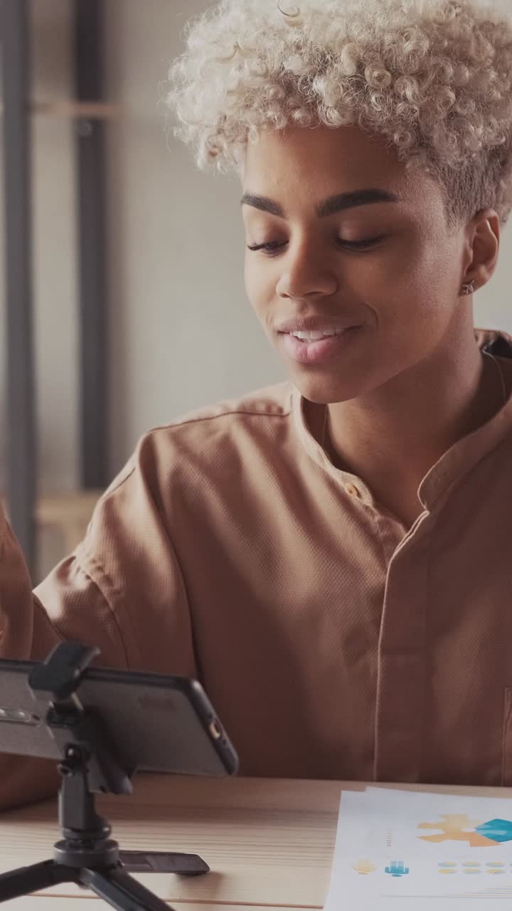 Young african american woman telecommuter talking via video call in phone