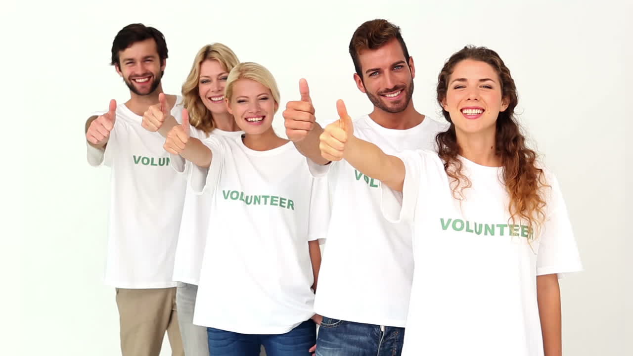 Team of volunteers giving thumbs up to camera