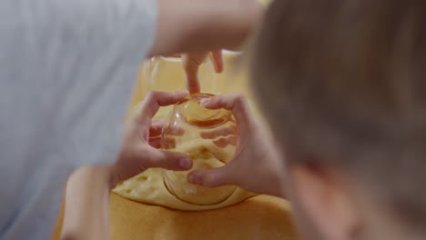 kids cutting dough with drinking glasses