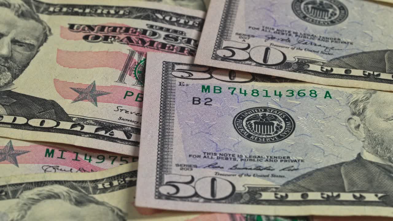 50 dollar bills stacked with a close view of money in the United States