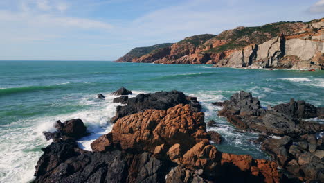 stormy powerful sea waves splashing at rough seashore cliffs. aerial shore rocks