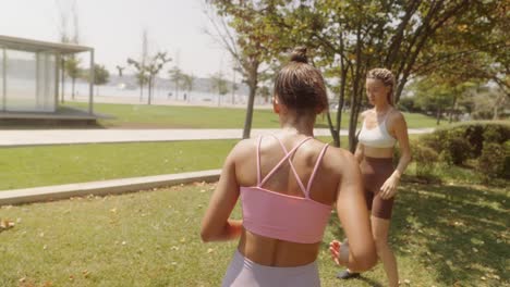women exercising and playing soccer in the park
