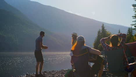 group of friends camping near riverside 4k