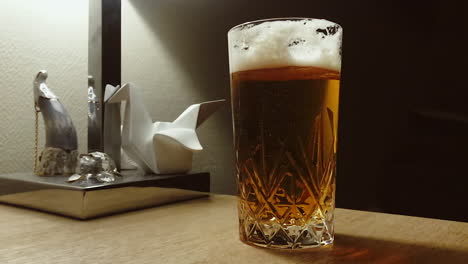 cold beer in a glass with air bubbles and foam, close up