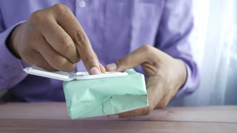 person opening a package of wet wipes