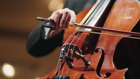 musician is playing old cello closeup view of violoncello classic music concert on scene of opera house