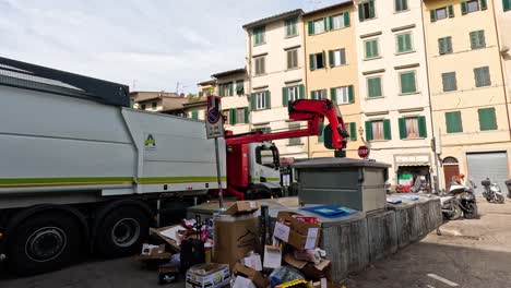 garbage truck empties bins in florence, italy