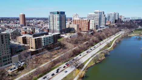 aerial flyby of large apartment buildings along a lake park