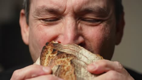 A Journey of Enjoyment: Capturing the Moment of Delight in Savoring Each Bite of a Delicious Sandwich with Pure Satisfaction and Joy