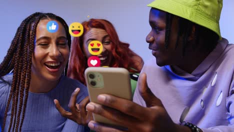 group of gen z friends looking at mobile phone with motion graphics emojis showing multiple social media notifications liking and reacting to online content