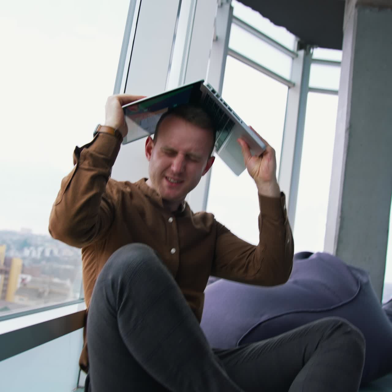 young man sitting on a floor with laptop computer. Work stress concept of man