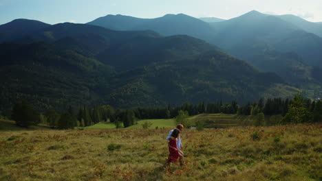 lovers in mountains walking grass enjoying amazing landscape blue sky background