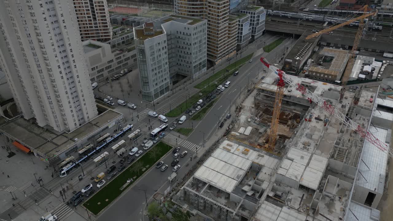 Construction site at Porte de la Chapelle in Paris, crane, unfinished structures, and urban development, France. Aerial top-down view