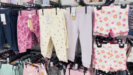 colorful kids' clothes arranged in a department store