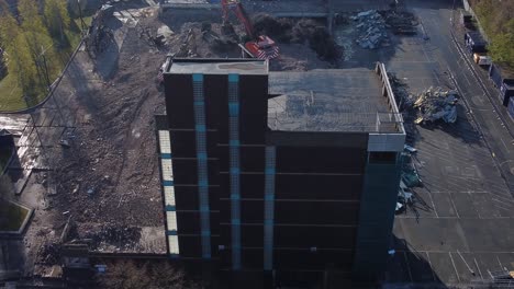 demolished multi storey car park concrete construction debris in town regeneration aerial view demolition site rear right orbit