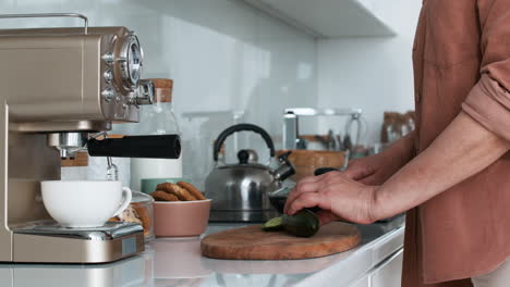 woman cutting cucumber