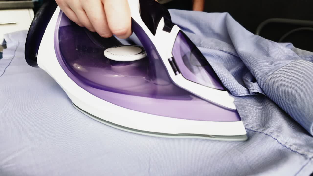 Male Hands Ironing Clothes With Iron On The Board With Steam Video