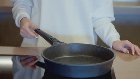 woman cooking on electric stove