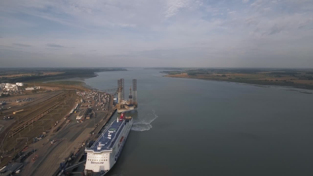 Aerial view of a large ferry docked at an industrial port along a river