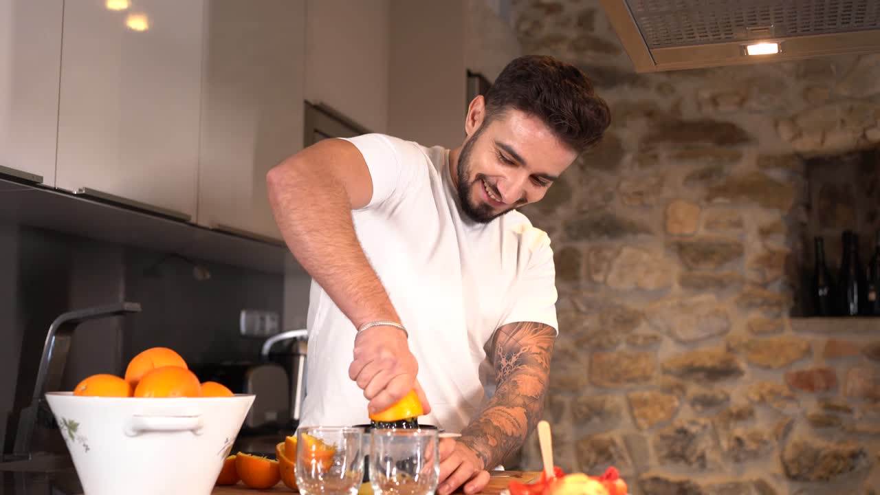 Man making orange juice in the kitchen