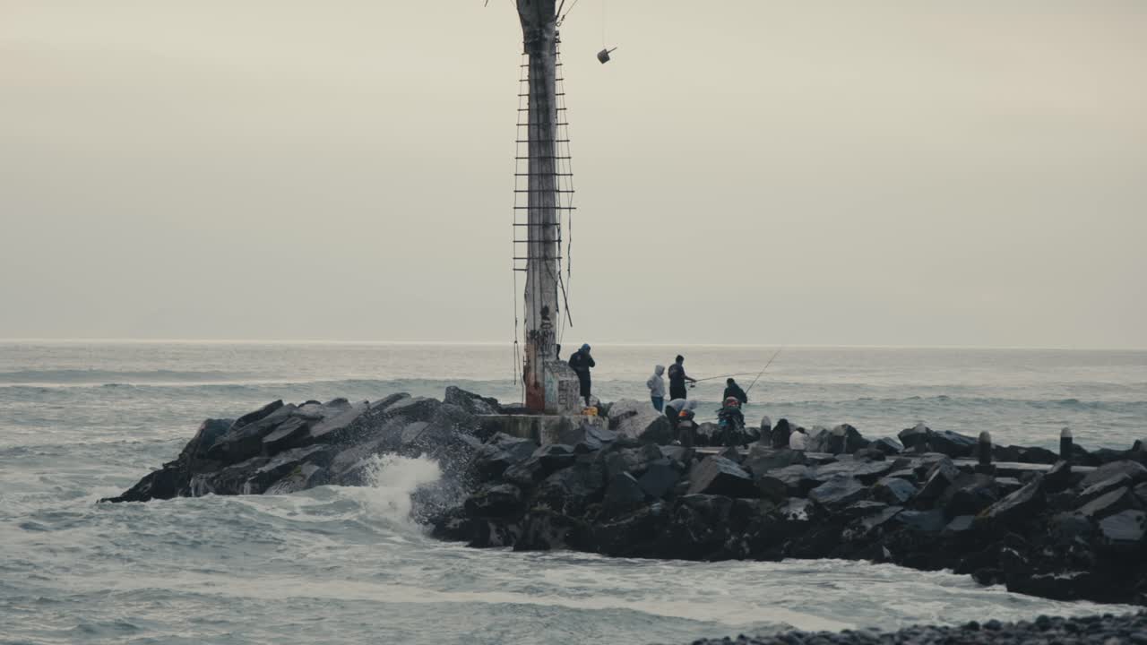 Fishermen on a Rocky Coast During a Storm
