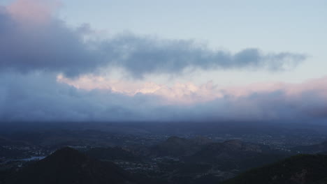 time lapse of thick storm clouds rolling by above westlake village at sunset. filmed on red dragon.